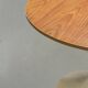 Mid-century round tulip dining table with a wooden top, vintage 1970s design.