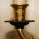 Pair of L'Originale wall sconces plated with 24-carat gold featuring four bronze candles.