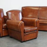 Very beautiful complete set consisting of a sheepskin leather sofa and two armchairs in cognac color