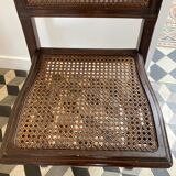 Vintage folding chair with cane seat in dark mahogany wood