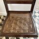 Vintage folding chair with cane seat in dark mahogany wood