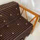 Two-seater bench convertible into a single bed.