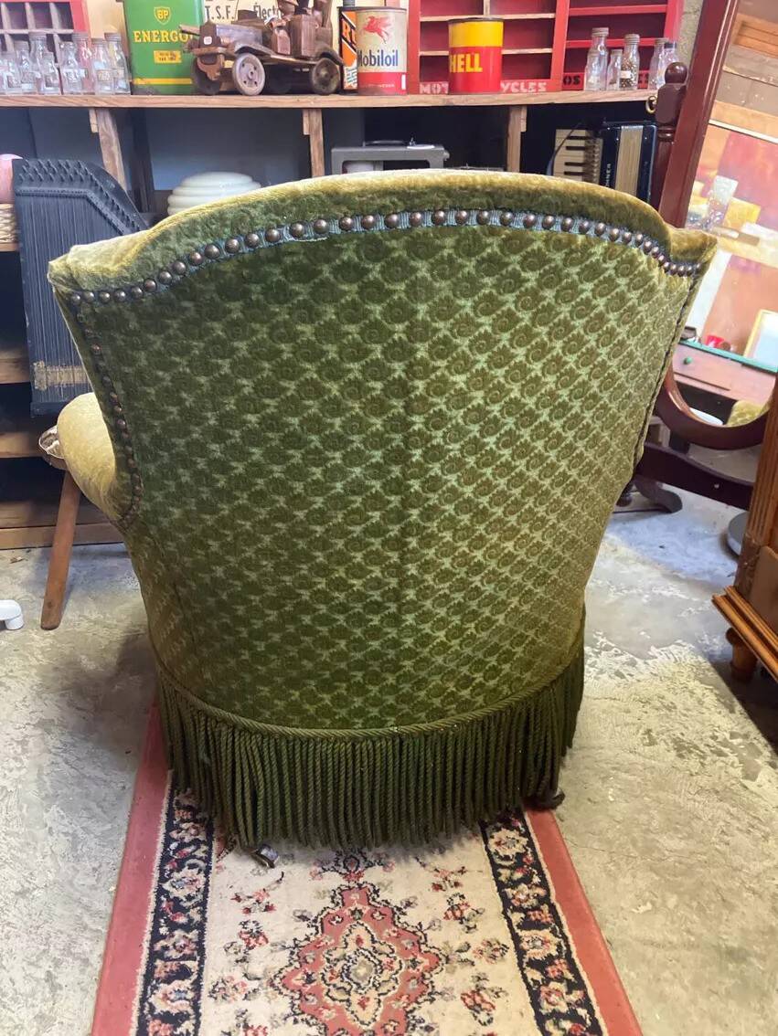 Green velvet toad armchair with wheels and fringes