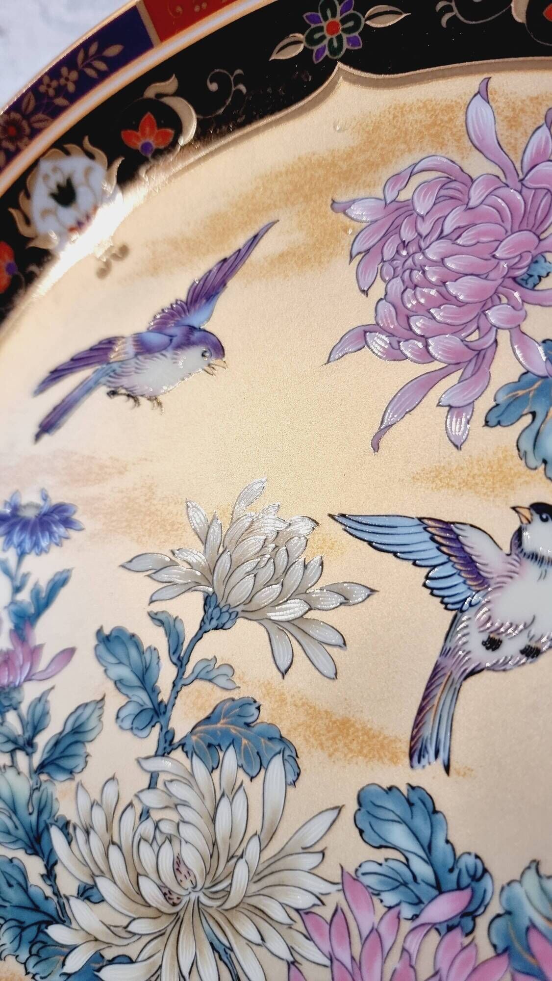 Vintage Japanese decorative plate with chrysanthemum and bird patterns.