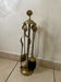 Vintage brass fireplace companion with shell decoration.