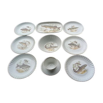 vintage porcelain dinner service with fish pattern and gold trim