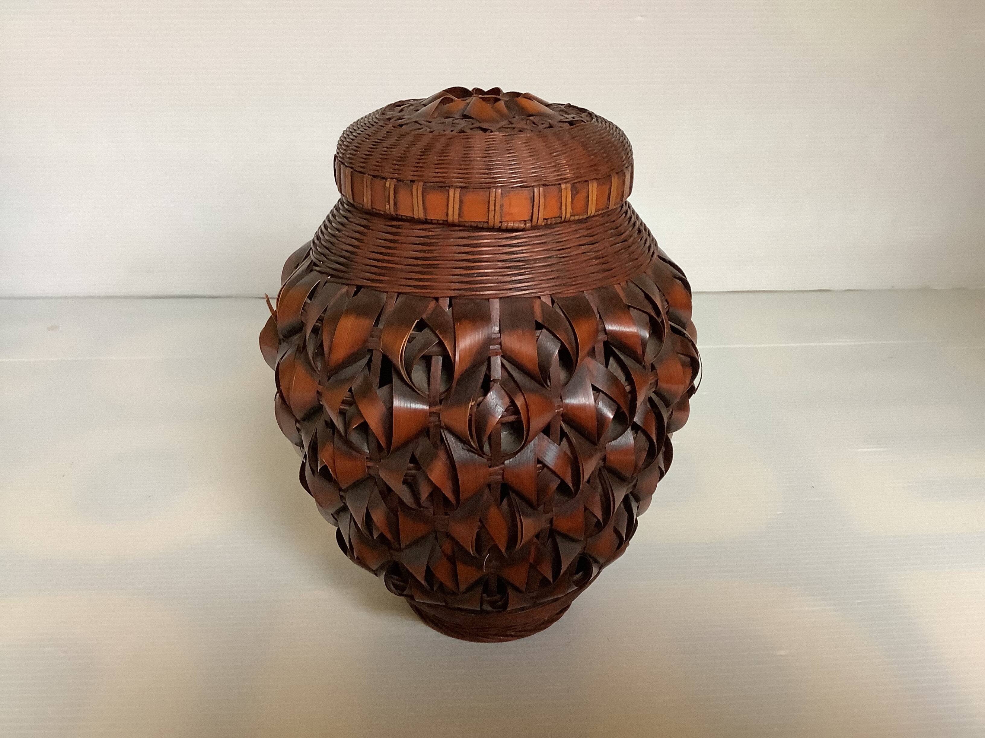 Covered wooden vase covered with woven bamboo