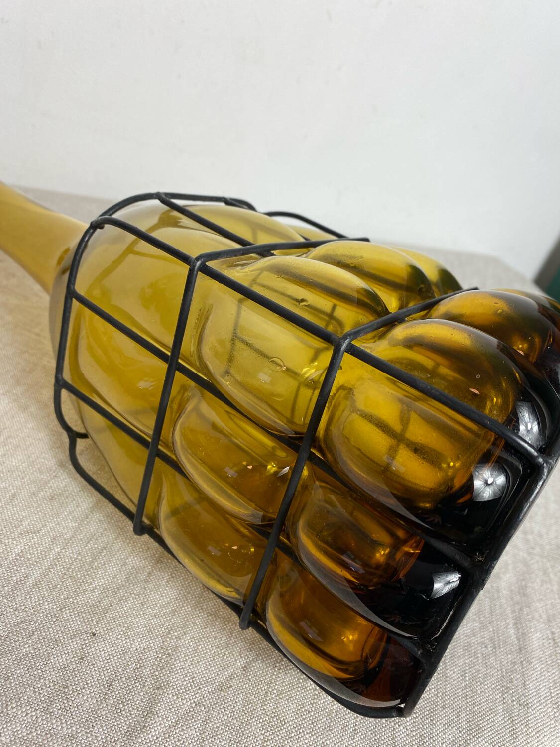 Glass carafe encased in wrought iron