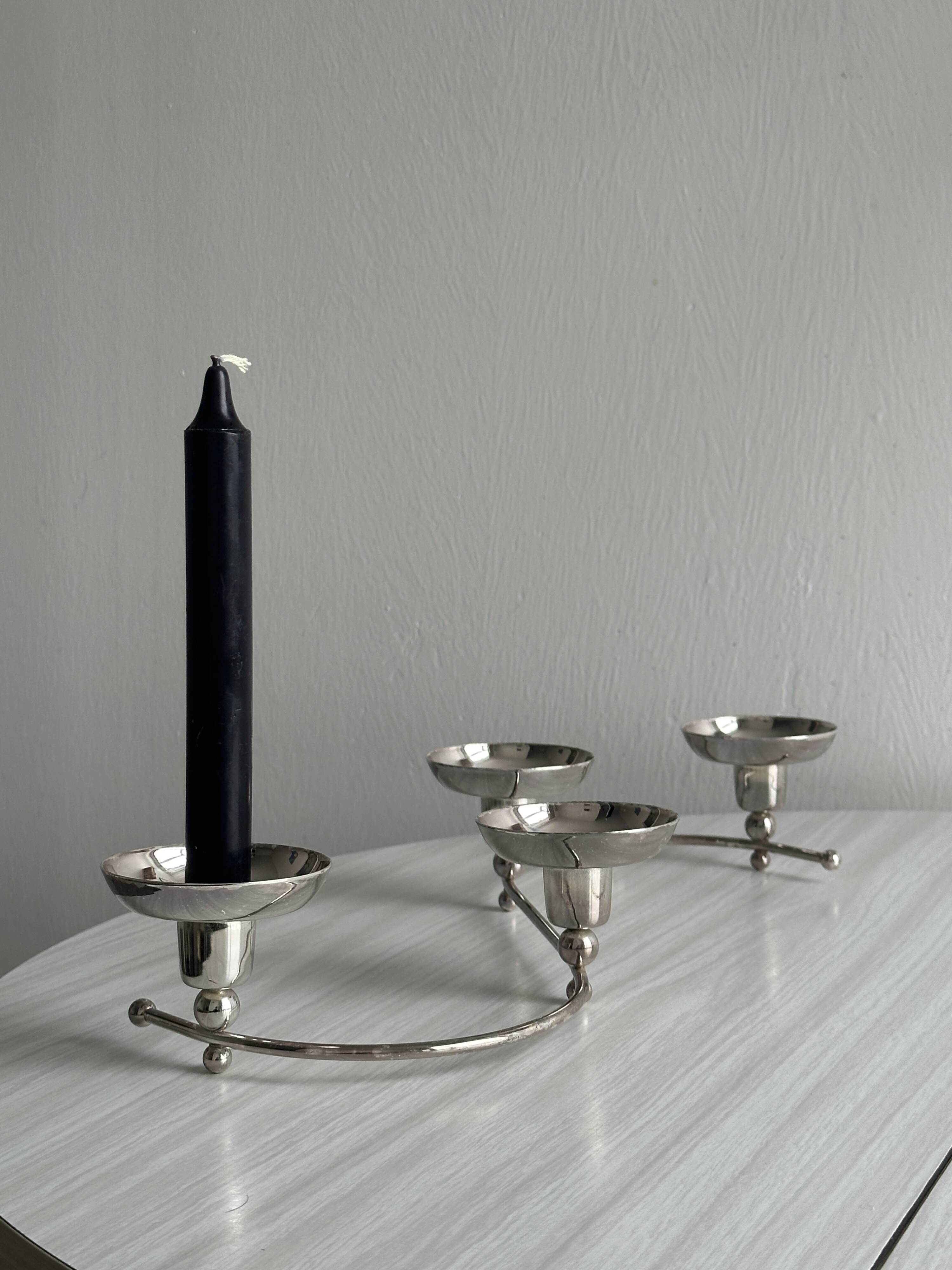 Shiny stainless steel candlestick holder