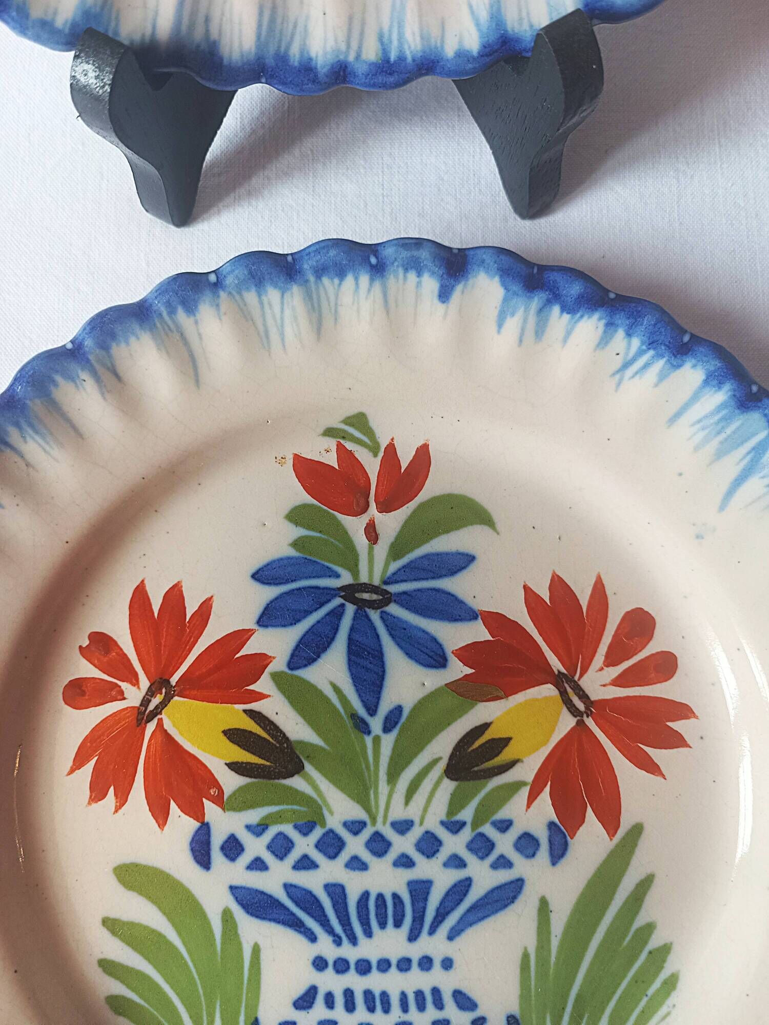 Pair of antique plates in popular earthenware with a floral basket decoration on the edge.