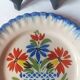 Pair of antique plates in popular earthenware with a floral basket decoration on the edge.