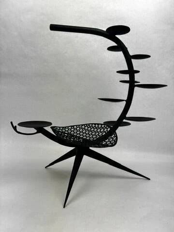 Candlestick sculpture in perforated iron clover motif