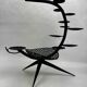 Candlestick sculpture in perforated iron clover motif