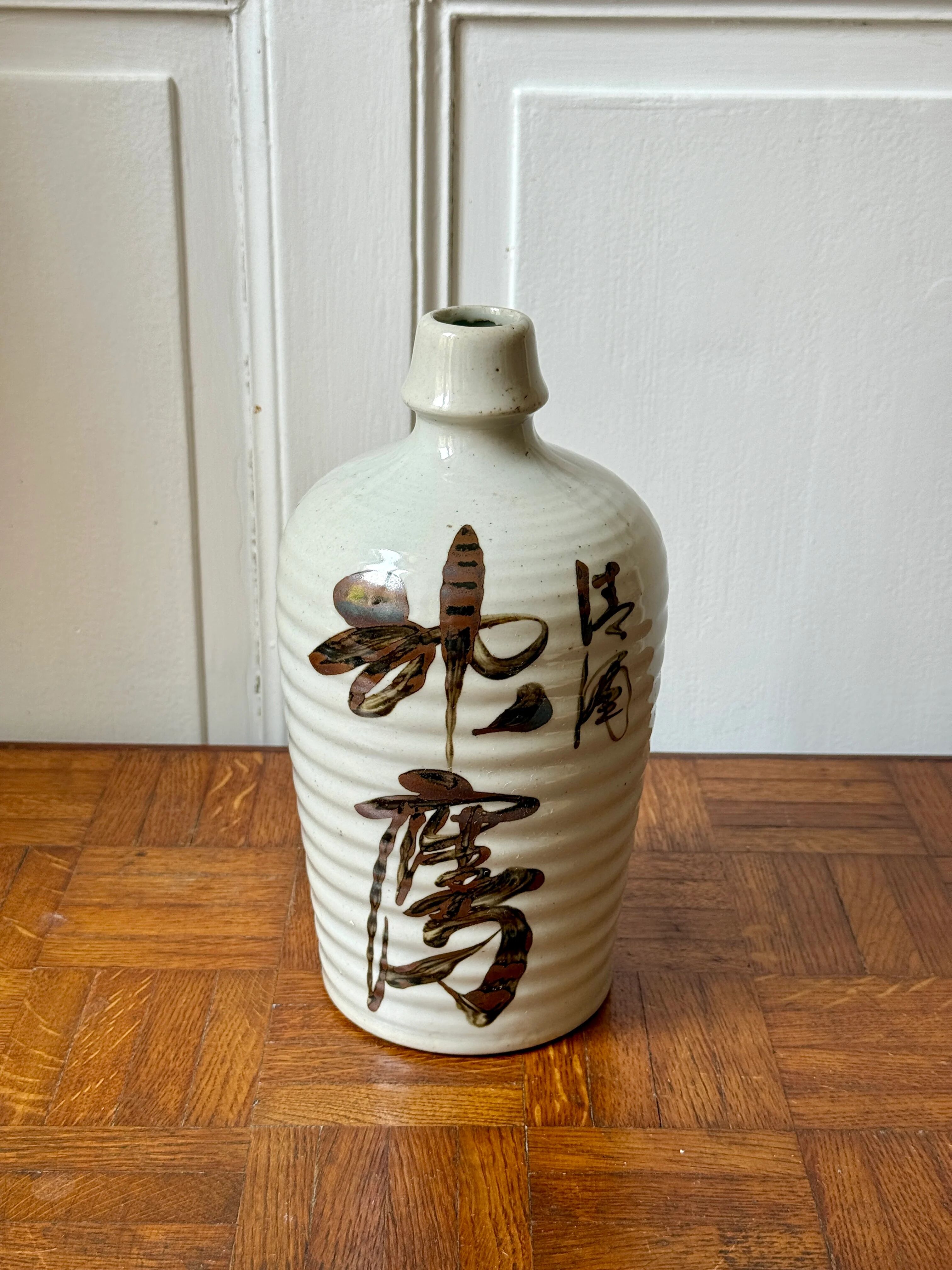 Old Japanese sake bottle in tokkuri shape.