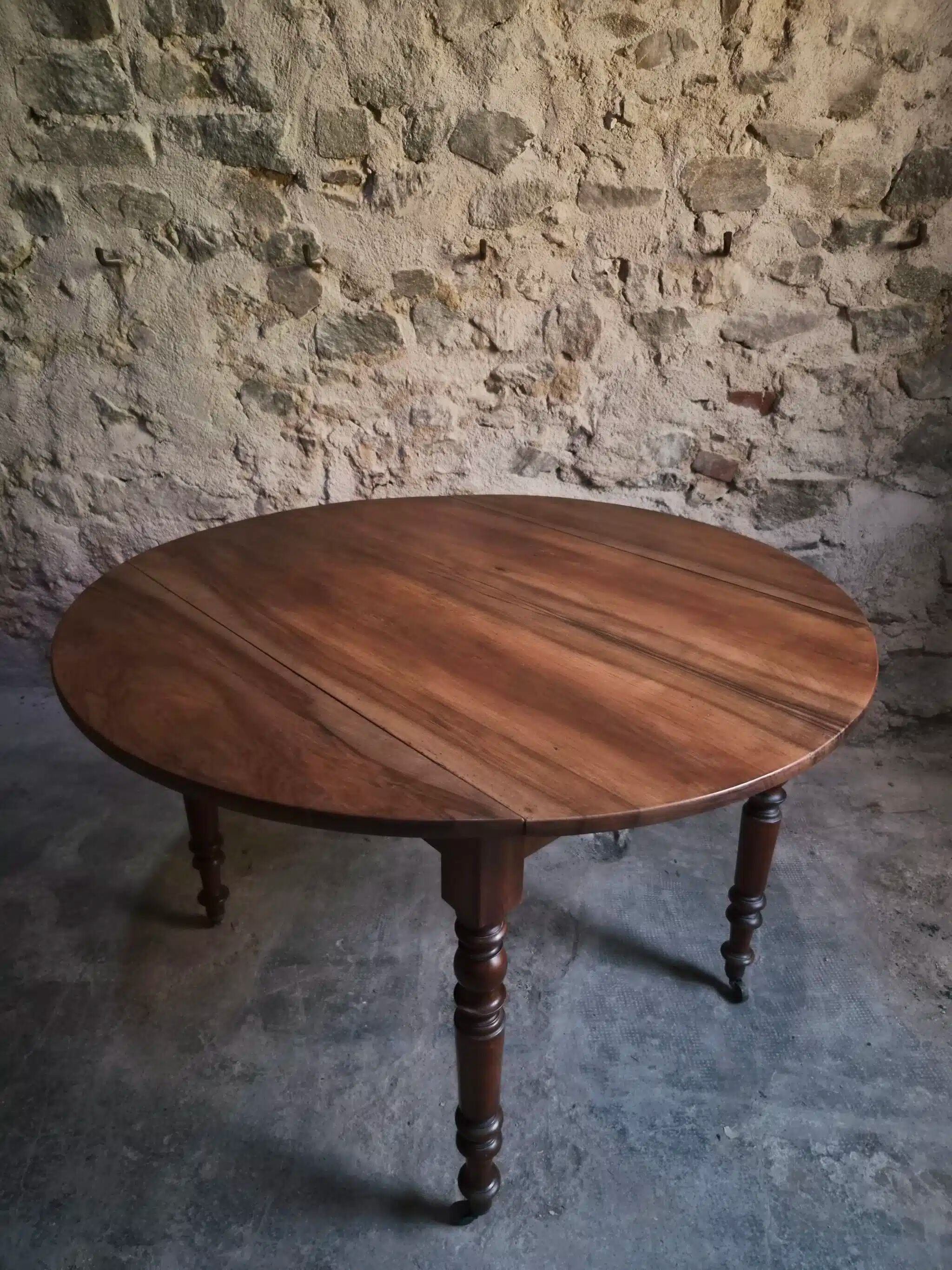 Antique drop-leaf dining table in walnut, France, circa 1900.