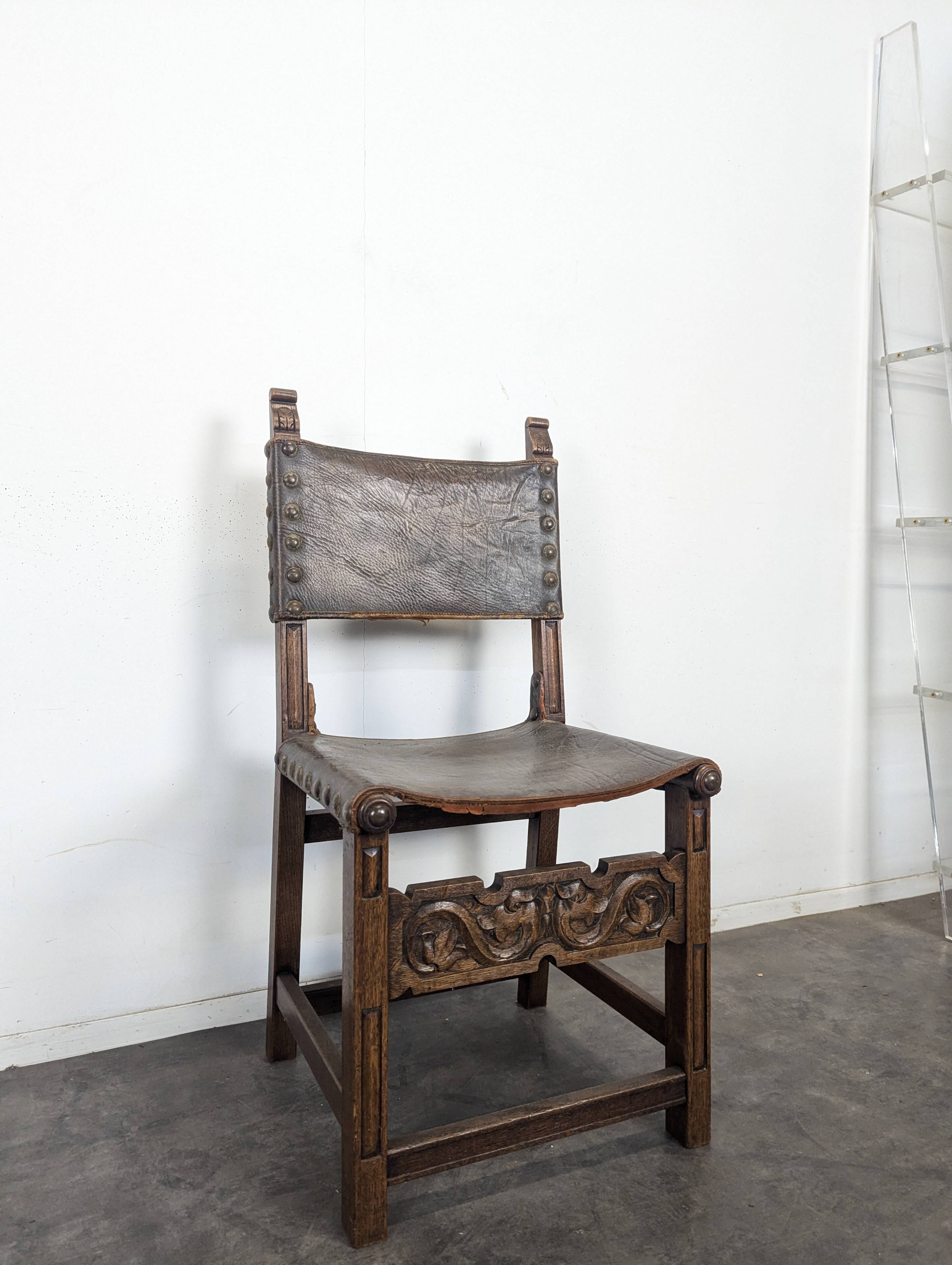 Set of 8 Gothic-style chairs in oak and studded leather.