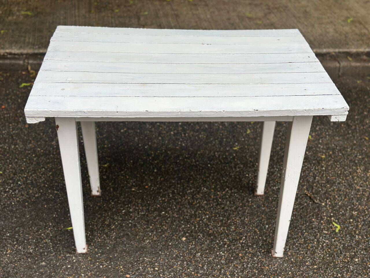 Vintage white wooden kitchen table with drawer from the 19th century.