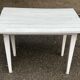 Vintage white wooden kitchen table with drawer from the 19th century.