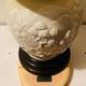 1980s ceramic table lamp with a wooden base and adjustable shade.