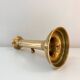 Old brass candlestick with push button.