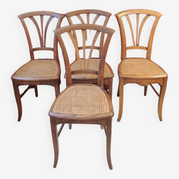 Lot de quatre chaises en bois et assise cannage /vintage