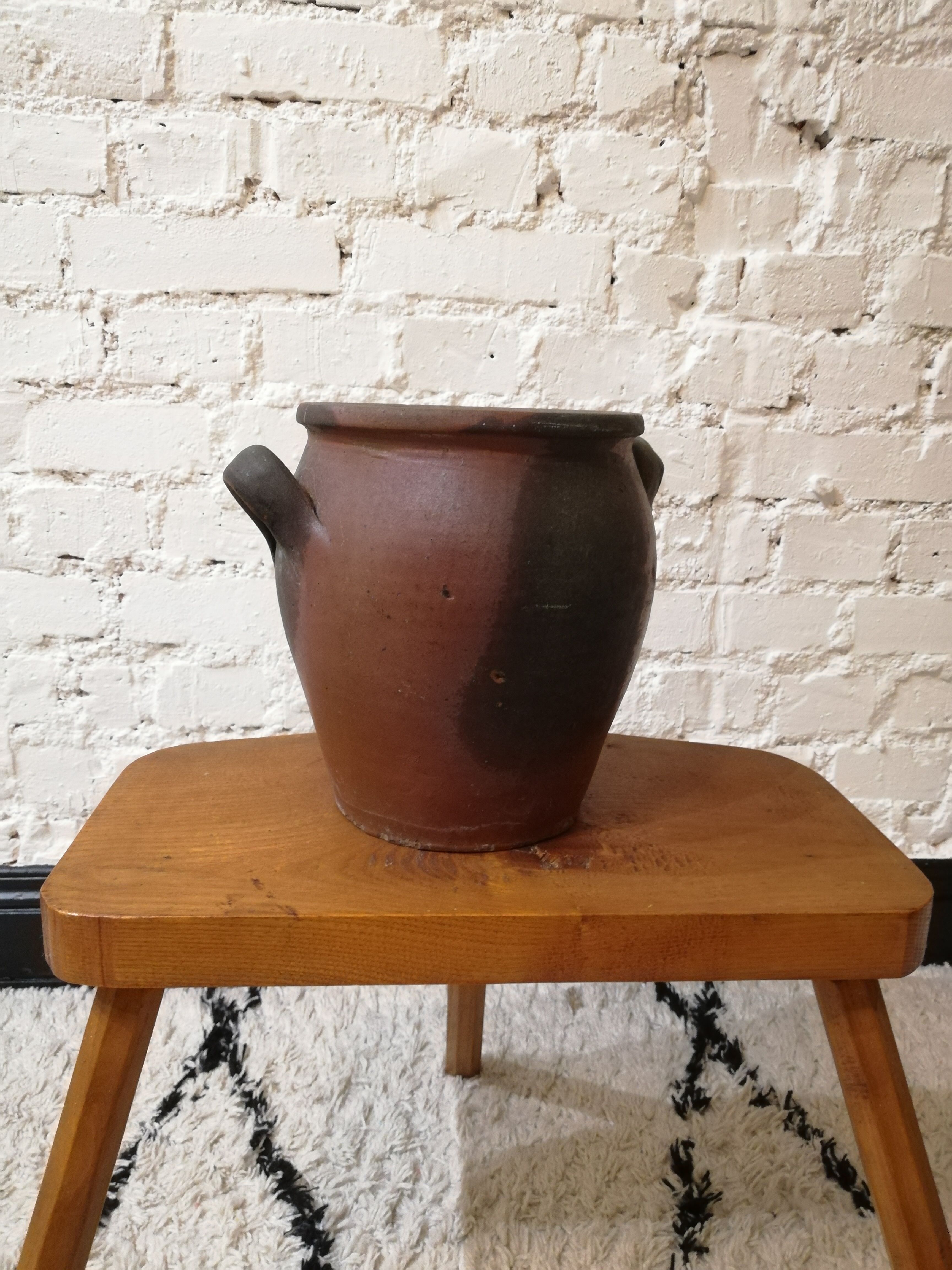Old red and black terracotta grease pot