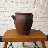 Old red and black terracotta grease pot