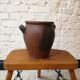 Old red and black terracotta grease pot