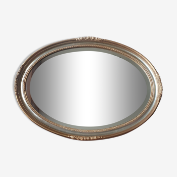 Golden oval mirror