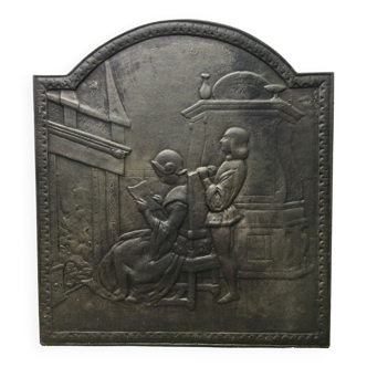 Plaque de cheminée « liseuse devant le feu »