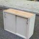 Vintage wall-mounted kitchen cabinet with sliding doors in 1960s retro style.