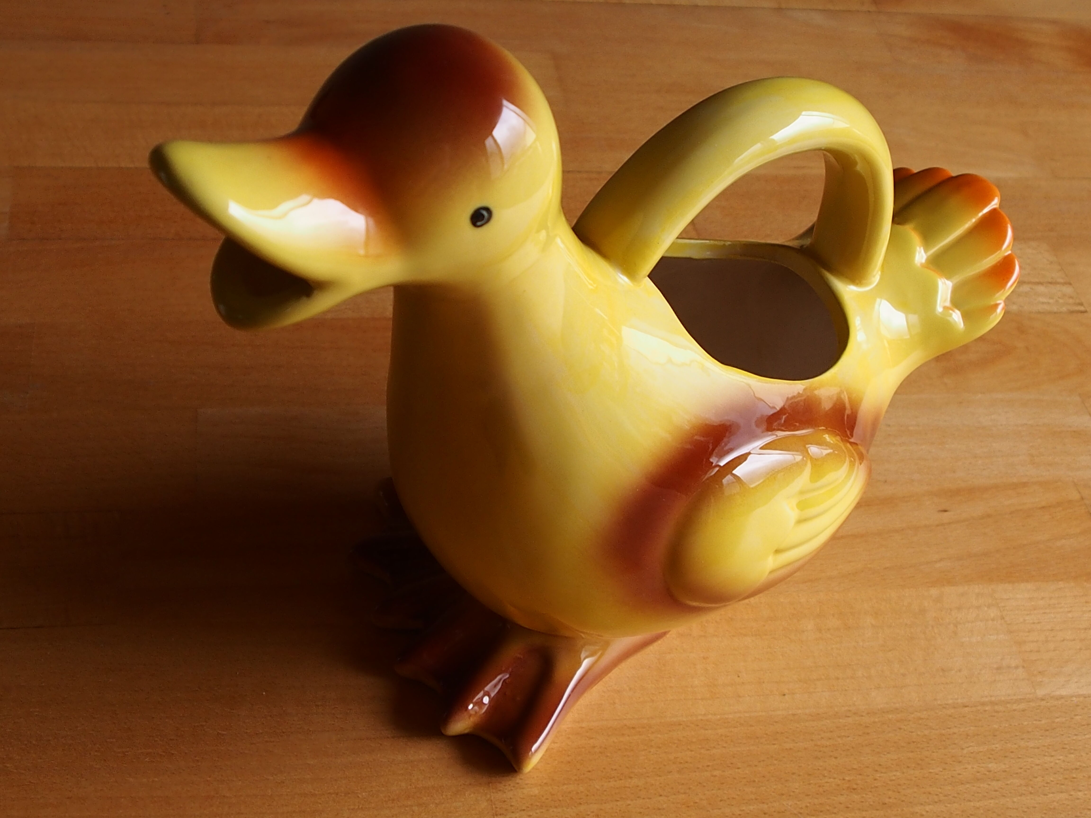Ceramic watering can in white earthenware, yellow enamel and bird shape