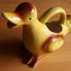 Ceramic watering can in white earthenware, yellow enamel and bird shape
