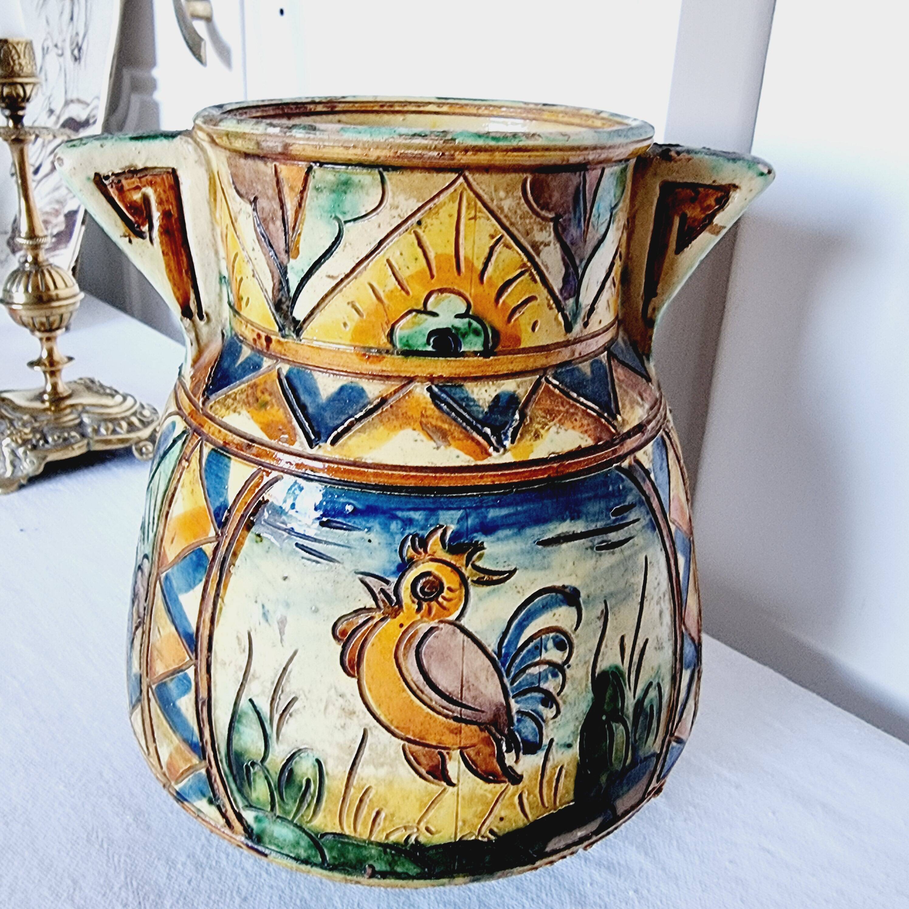 Antique majolica water pitcher made in Italy and hand painted.