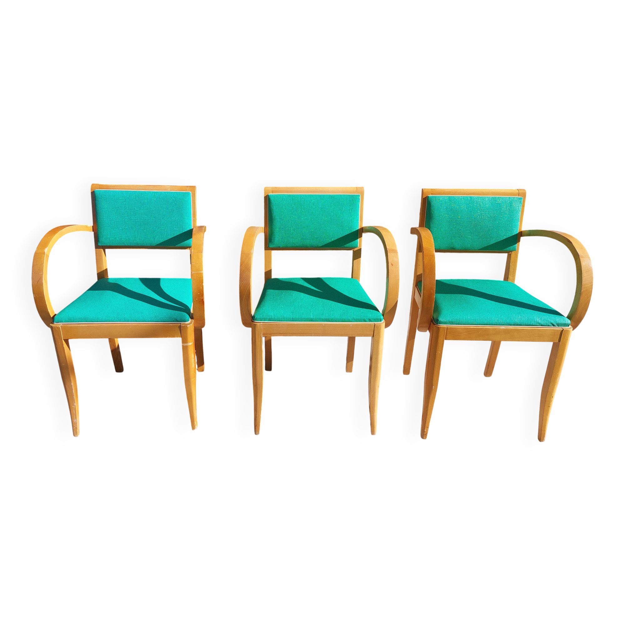 3 vintage bridge chairs with rounded armrests.