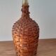 Demijohn surrounded by wicker
