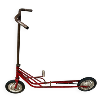 Trottinette rouge ancienne à pédale et chaîne