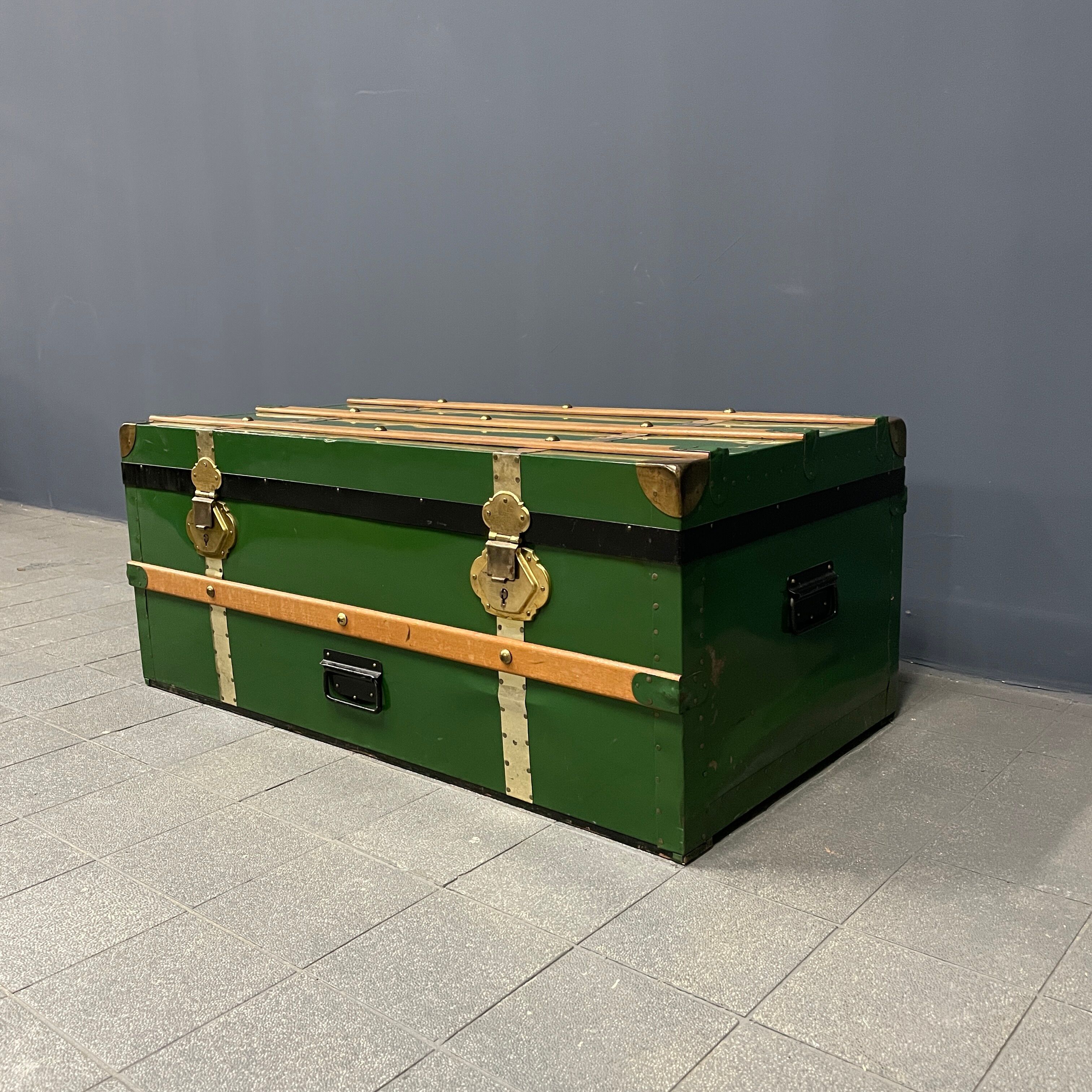 Green metal trunk with wooden sleds