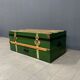 Green metal trunk with wooden sleds