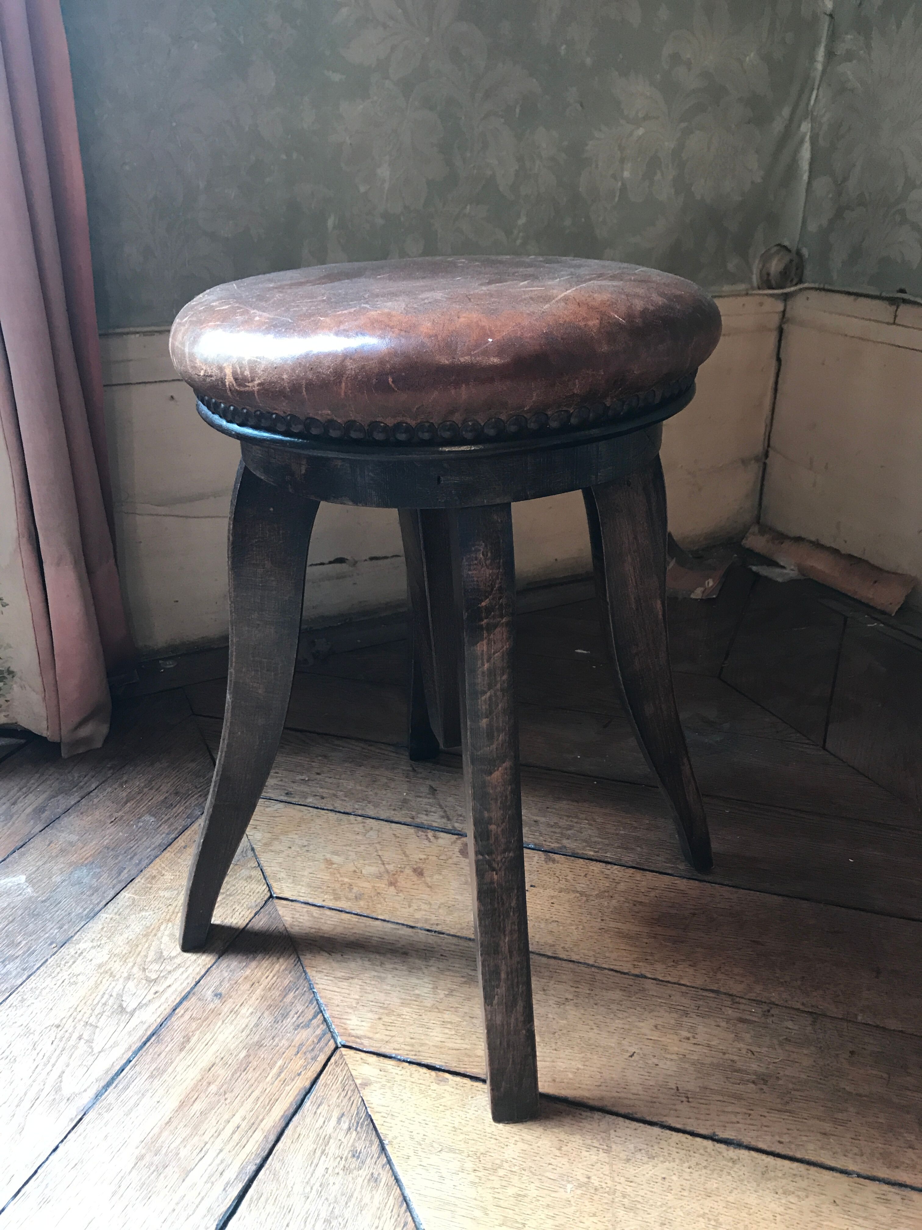 Old leather rotating piano stool