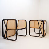 Pair of designer armchairs in curved wood and wicker