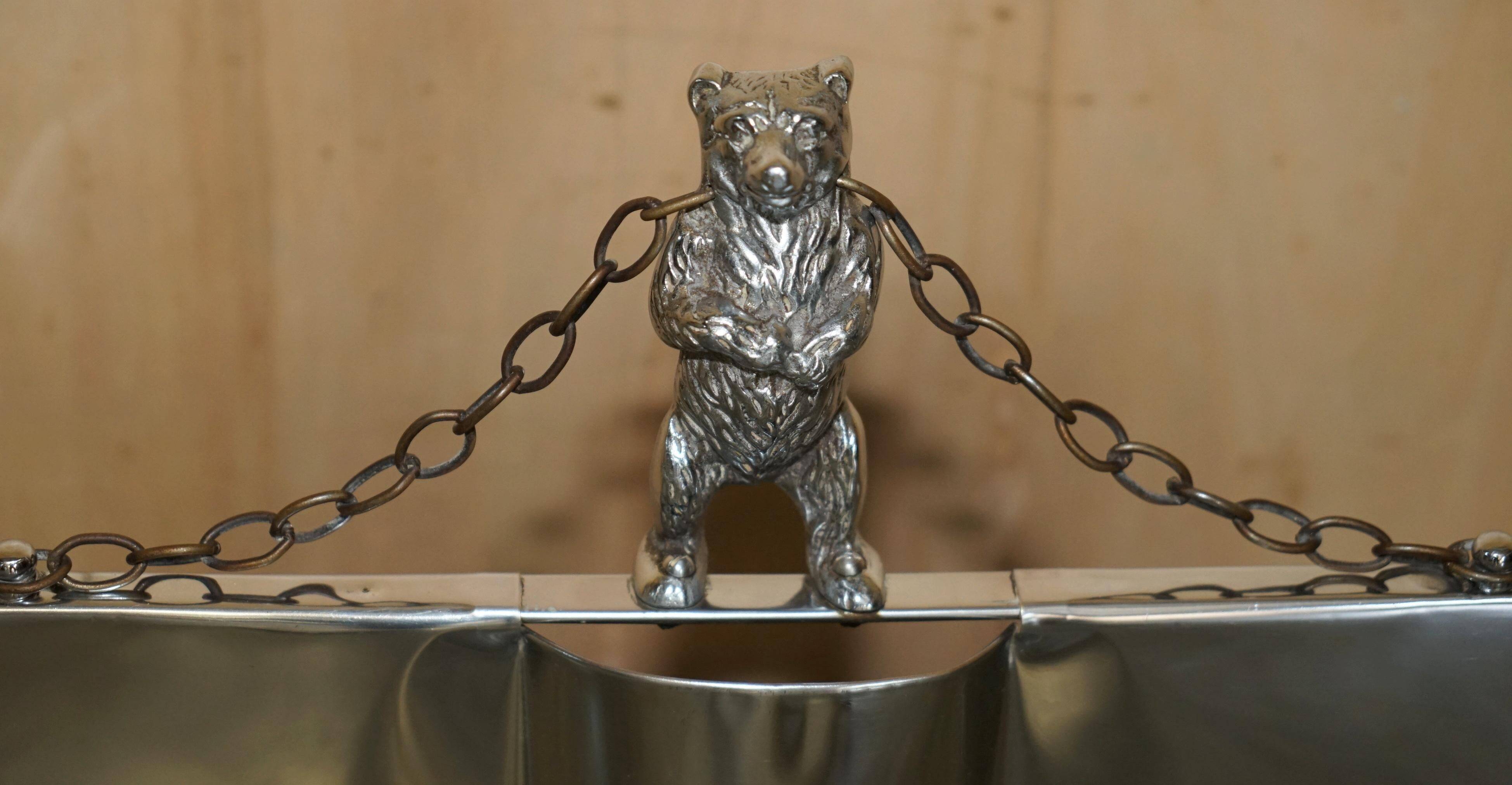 Art Deco fire screen from around 1920 in polished chrome with a bear.