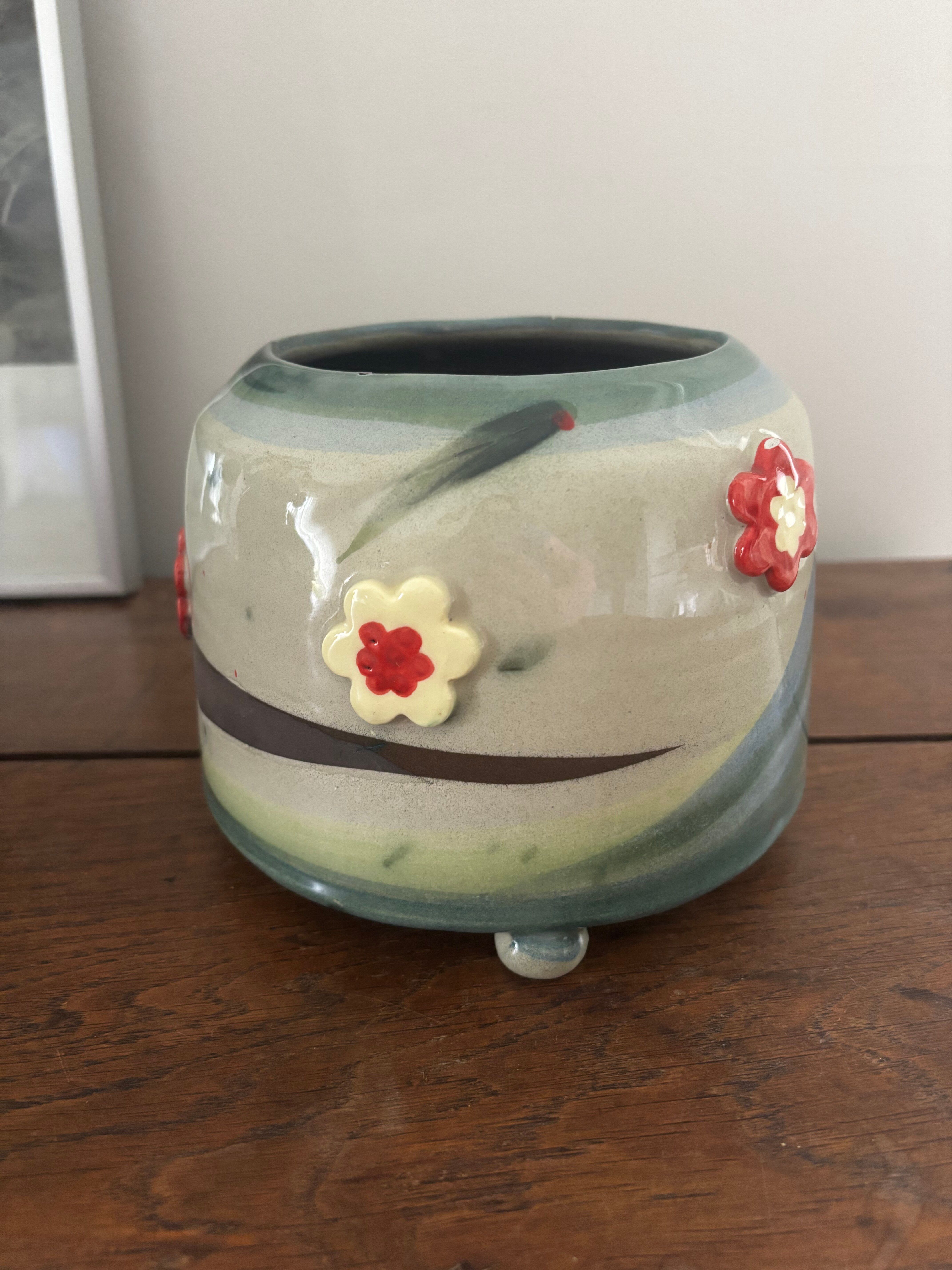 Superb handcrafted pottery pot with relief flowers signed on the back.
