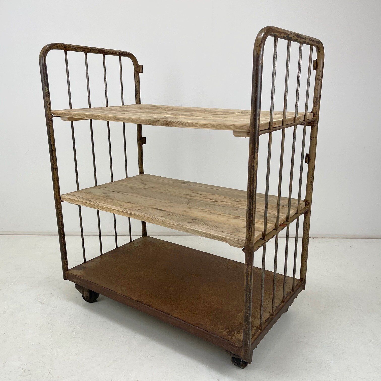 Vintage industrial iron and wood shelves on wheels