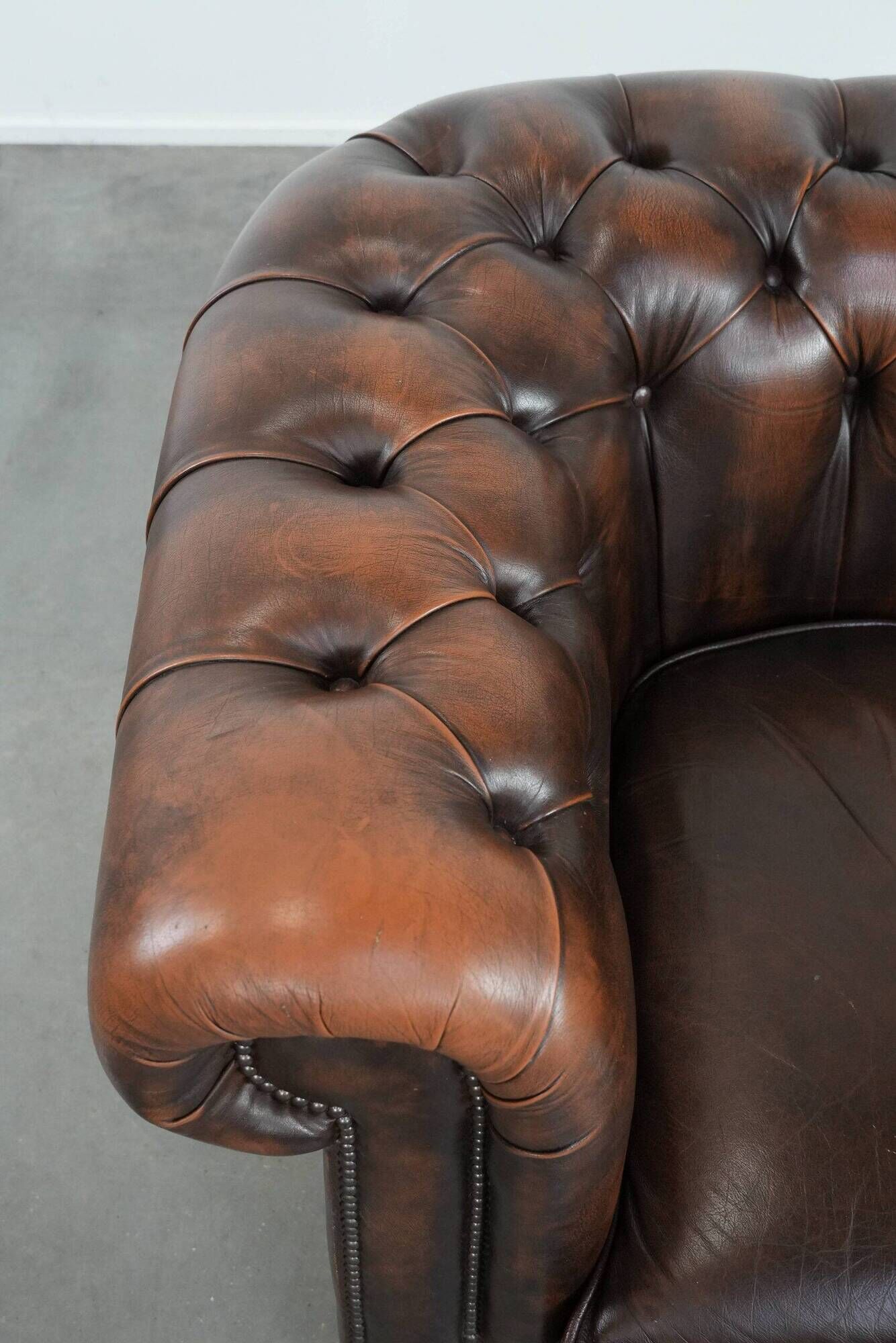 Brown Chesterfield armchair made of cowhide leather in English style
