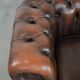 Brown Chesterfield armchair made of cowhide leather in English style