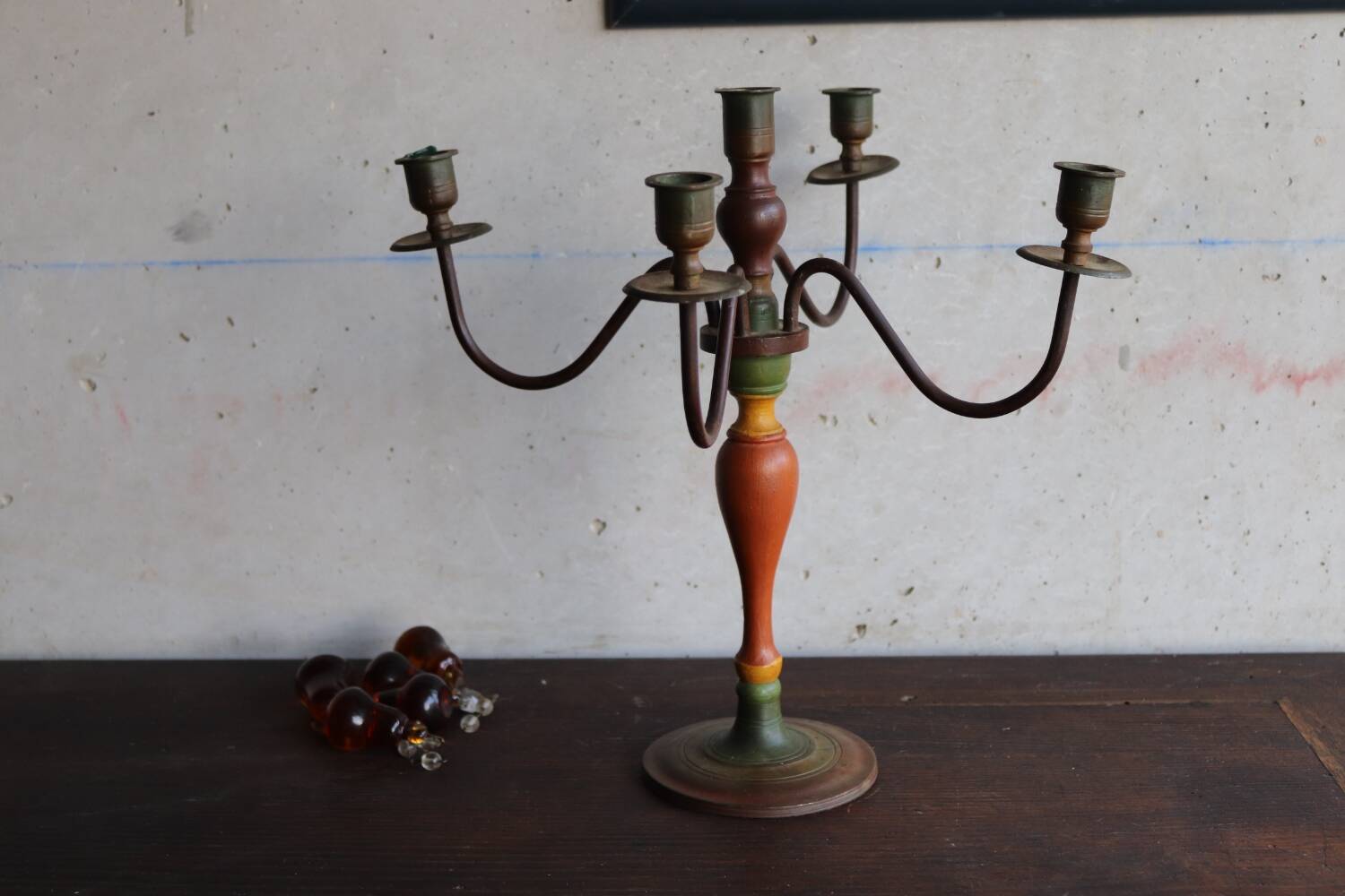 Old candlestick in painted wood and folding metal