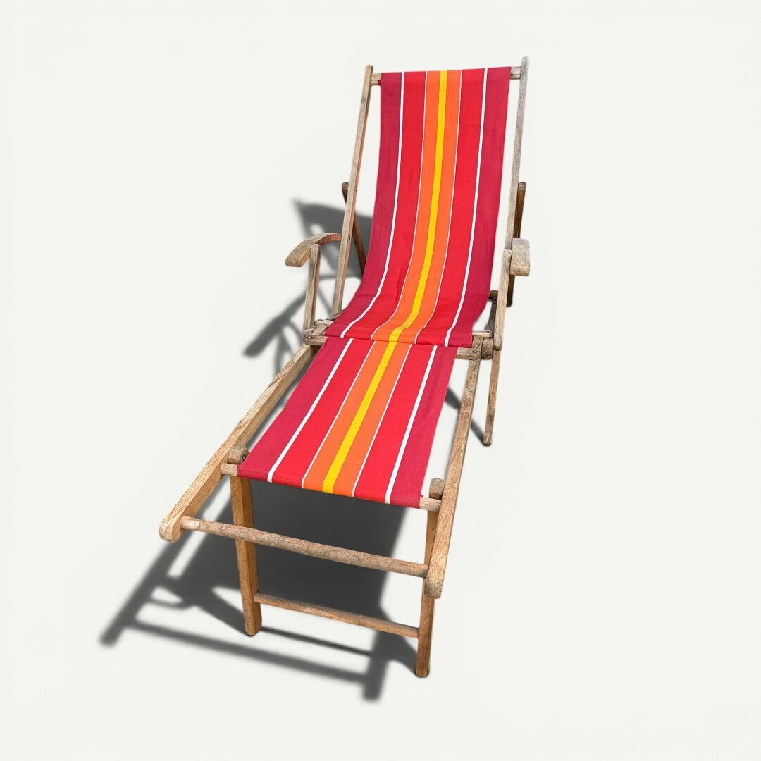 Vintage deck chair with red and orange striped fabric, original patina.
