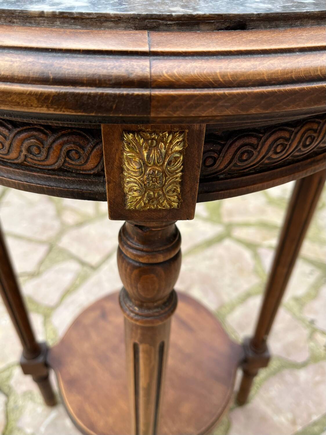 Old wooden pedestal table with marble top