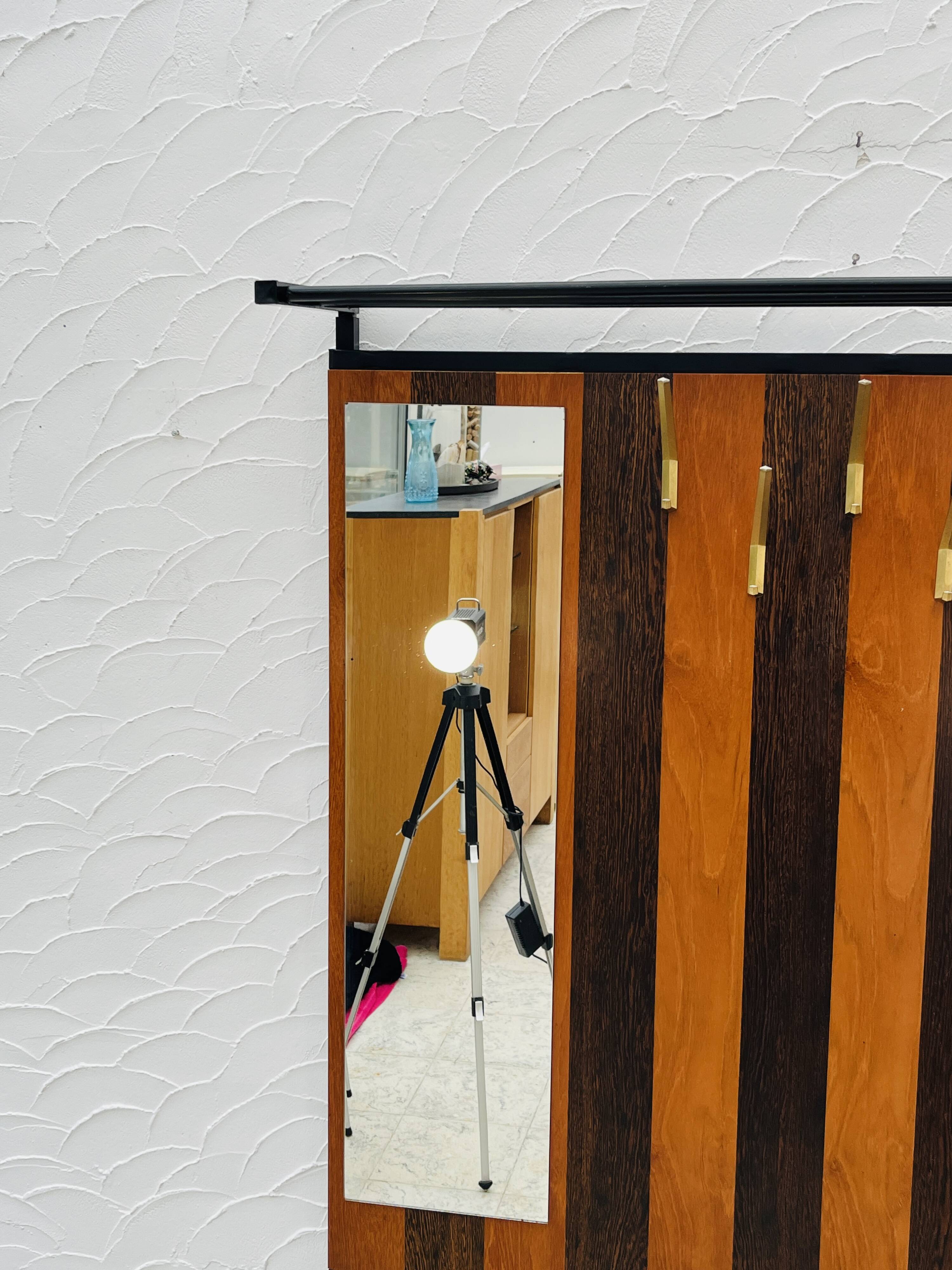Vintage wall coat rack with storage bench from the 1970s.
